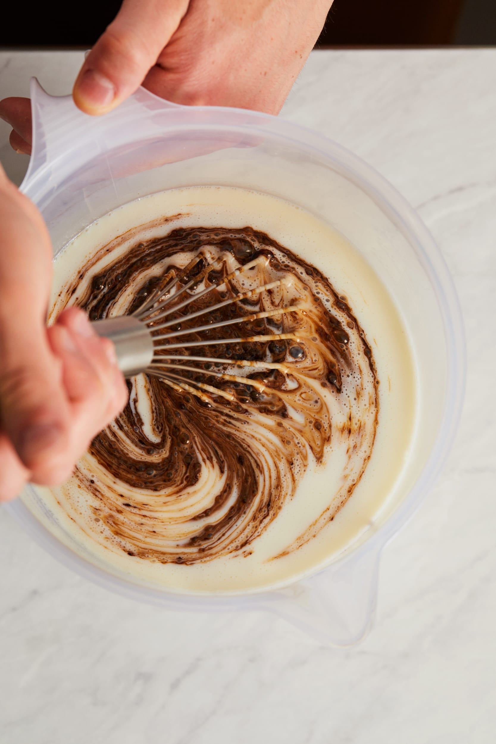 A person whisking icing