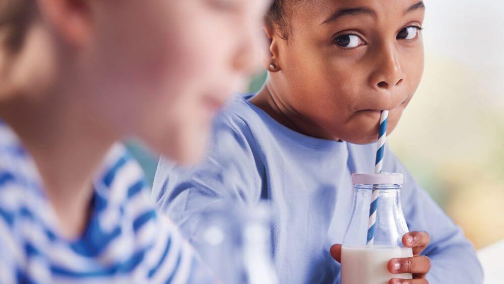 a child drinks a dairy drink enhanced with IFF's dairy solutions