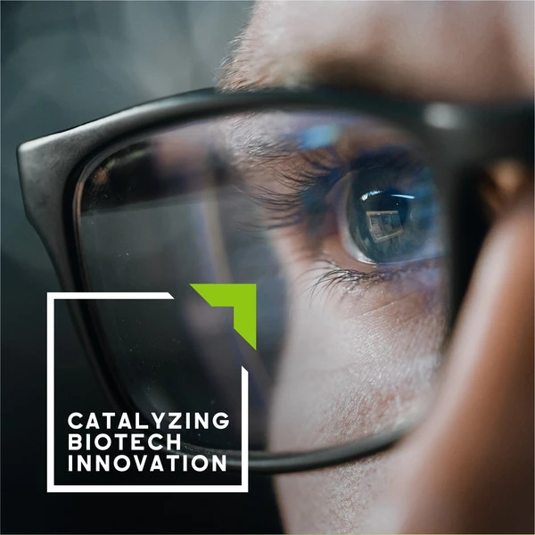 Close-up of a person's eye seen through glasses, with the text 