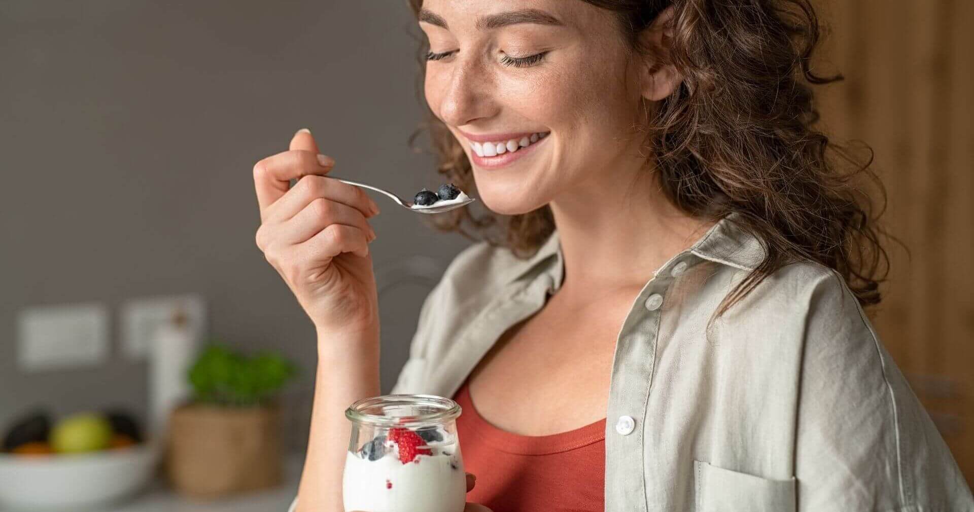 lady eating yogurt curly hair. Dairy cultures and enzymes