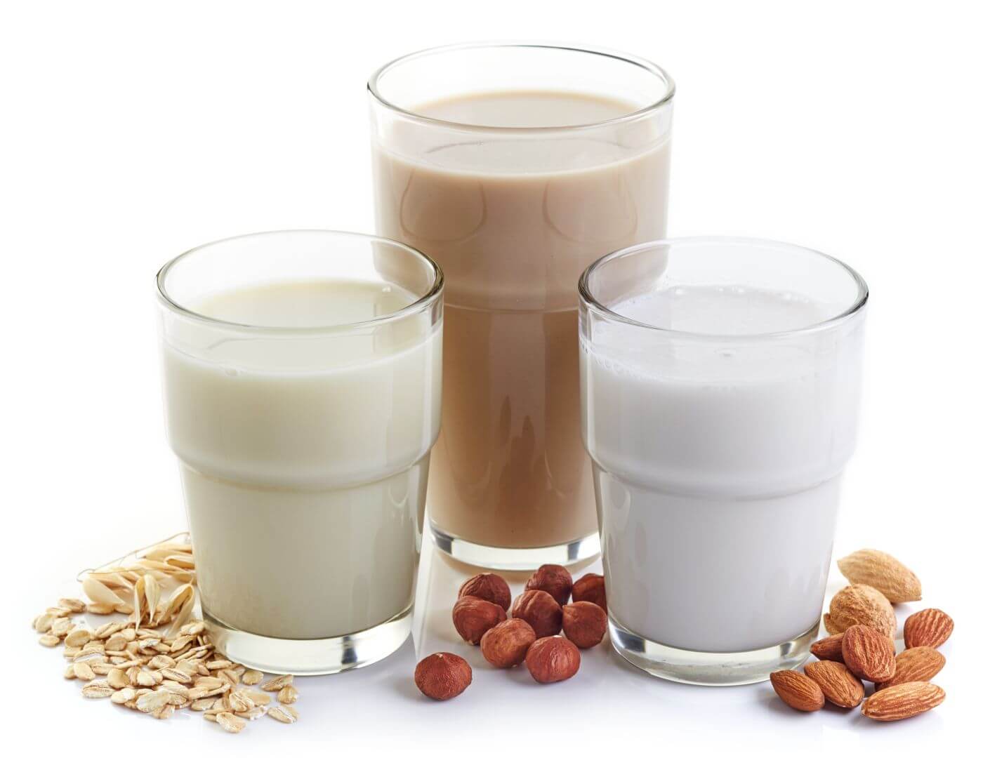 Three glasses of flavored milk, sitting next to each other.