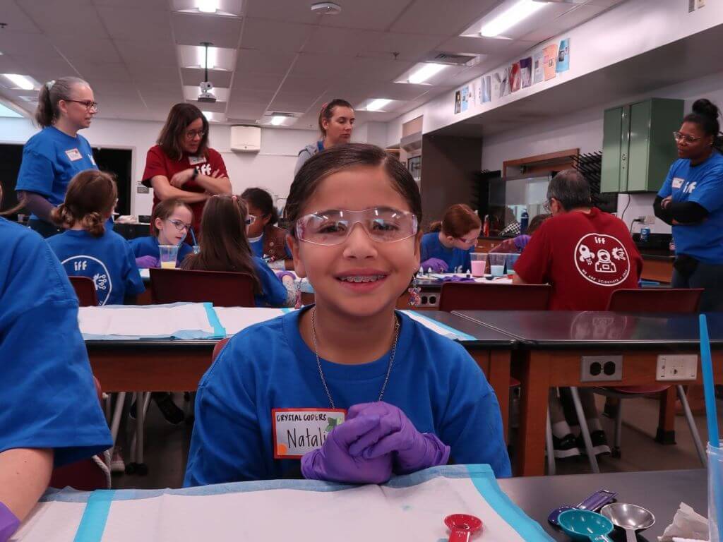 Girl scout with protective eyeglasses.
