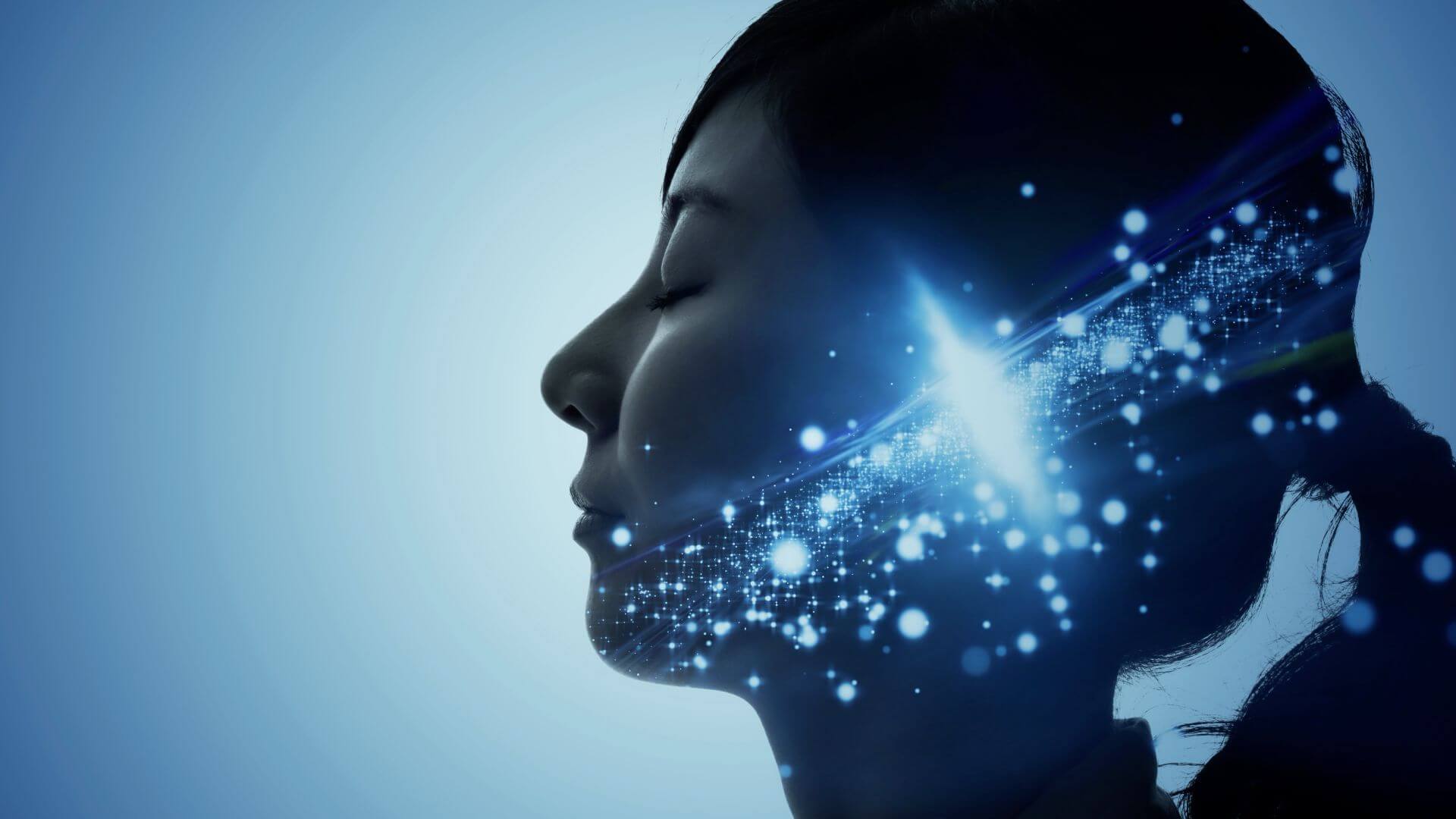 Side profile of a woman's face, eyes closed and face tilted up, with blue glowing neurons on the face and blue background