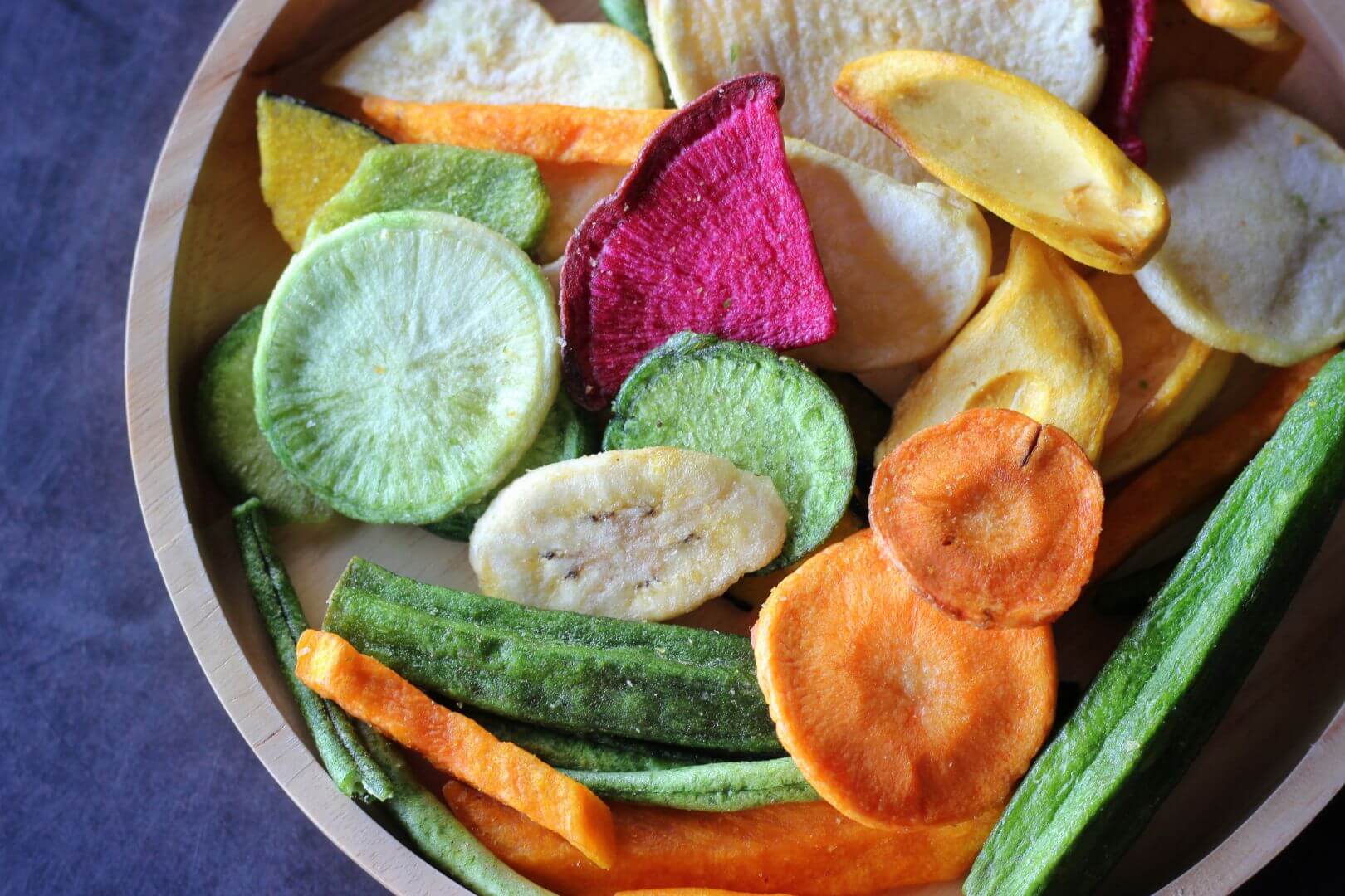 Bowl of a variety of veggie chips of different colors. Macro shot.